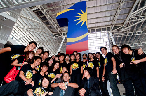 Students pose under the giant 1Malaysia structure.